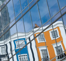 houses reflected in glass office windows