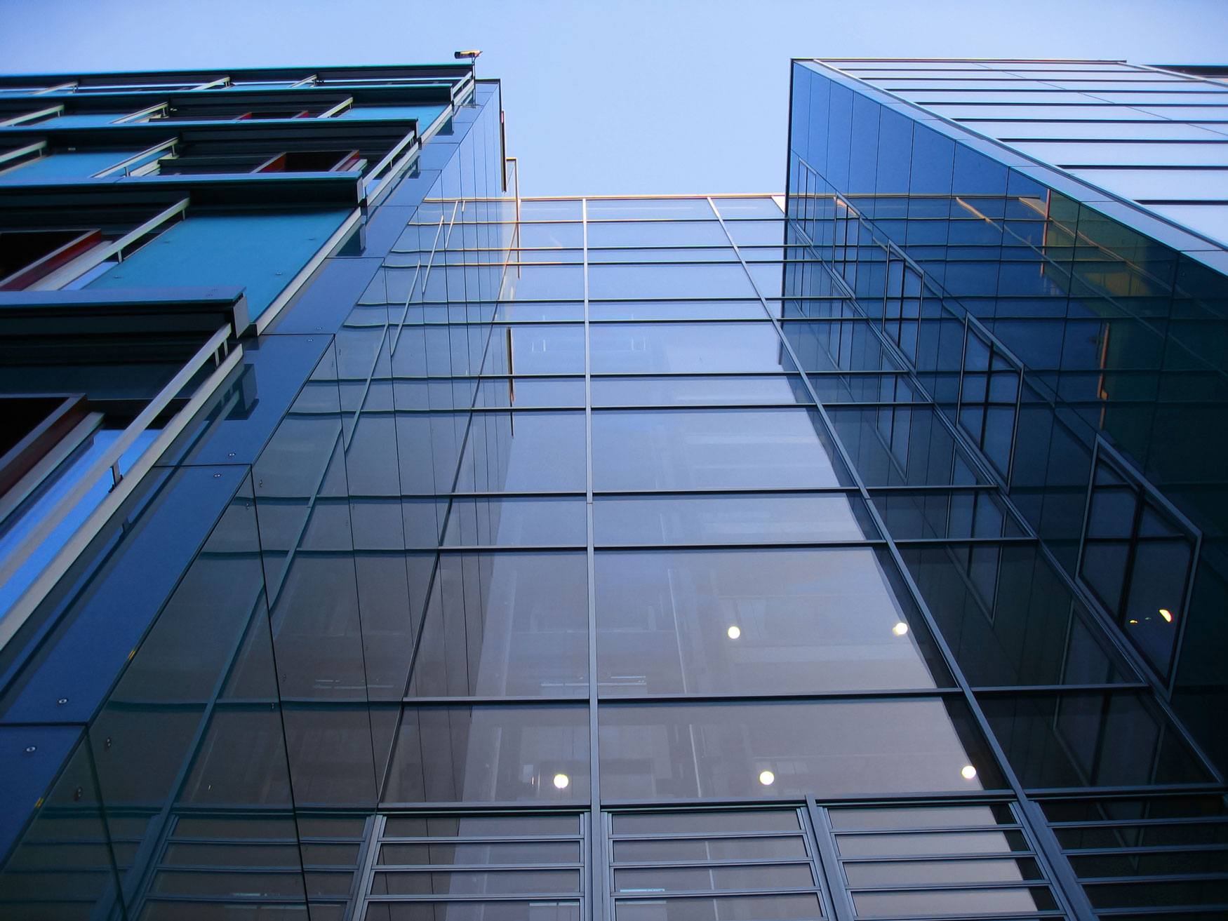 office and premises insurance, glass high rise office block viewed looking up from ground